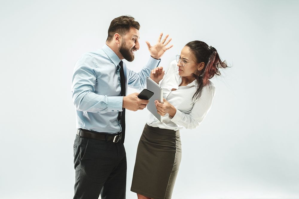 angry businessman and his colleague in the office.